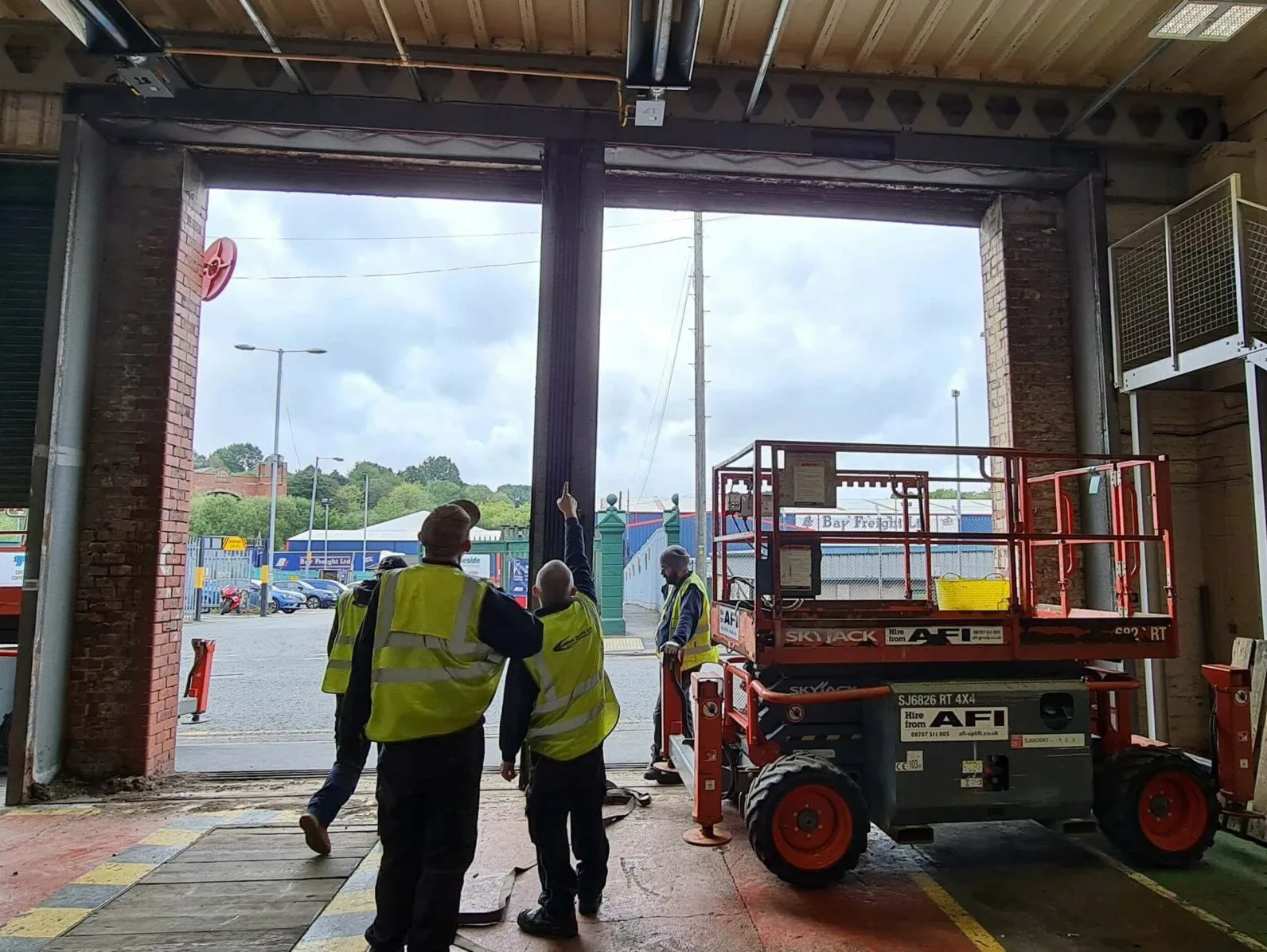 Industrial Roller Shutter Door Repair Engineers Assessing an Industrial Roller Shutter Door for Repair